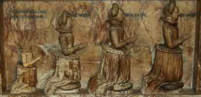 row of 4 daughters carved on side of tomb